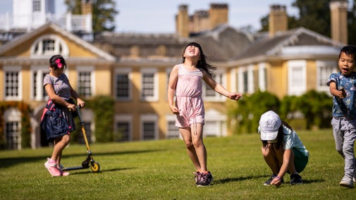 Children playing in the garden on a sunny day in August at Polesden Lacey, Surrey